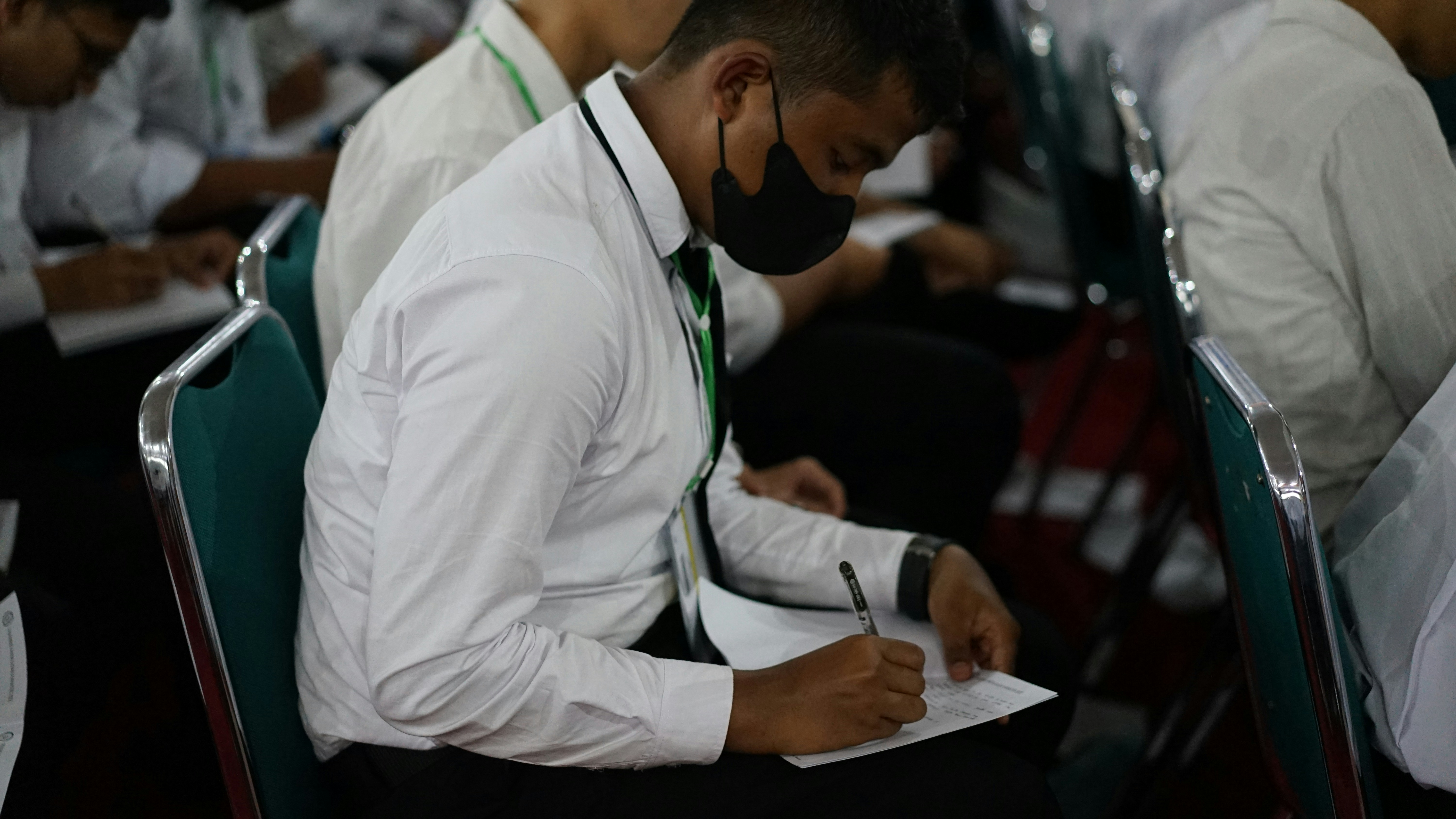 Close-up of an aspirant writing a competitive exam