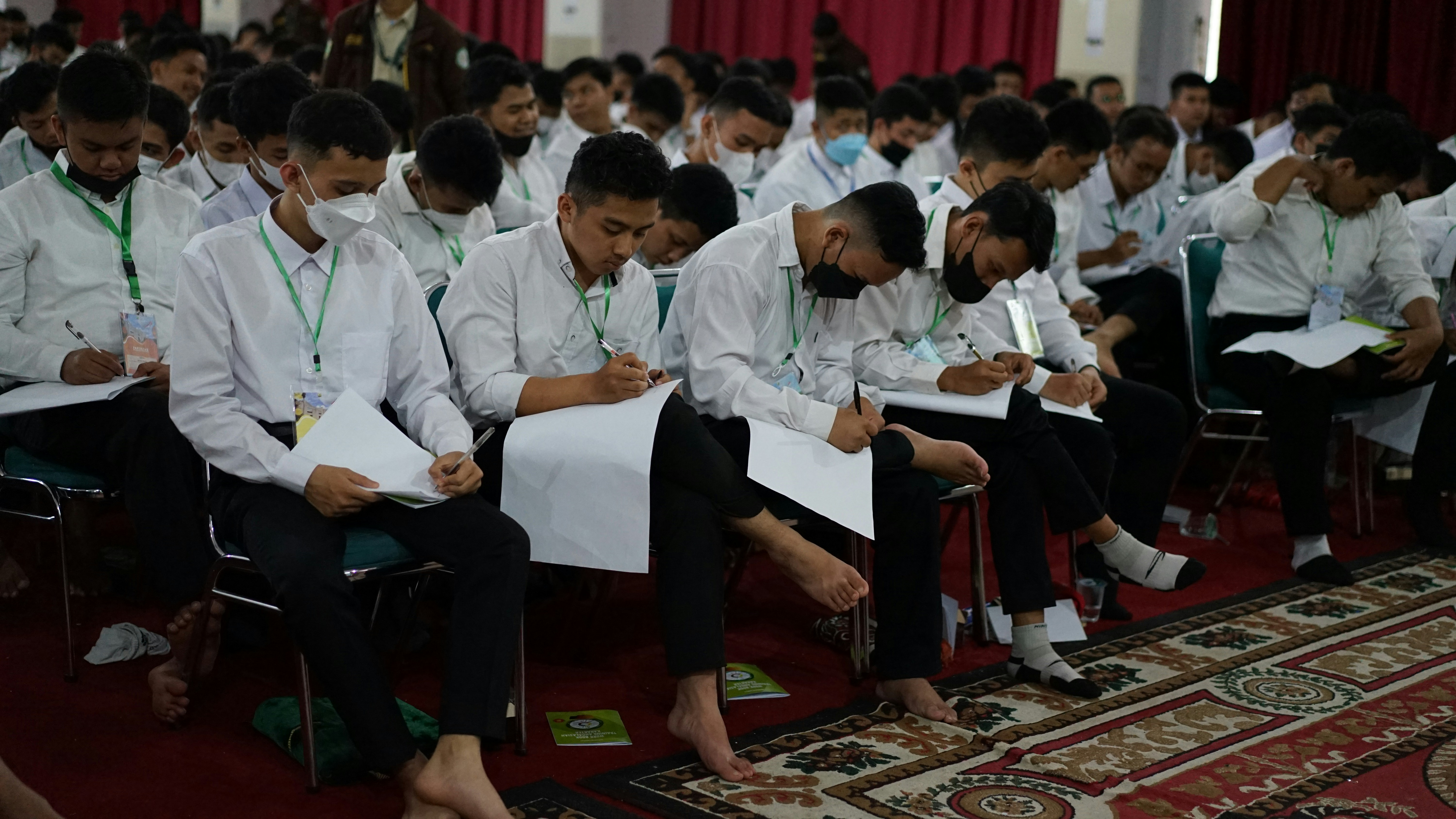 Candidates sitting in rows during a competitive exam hall