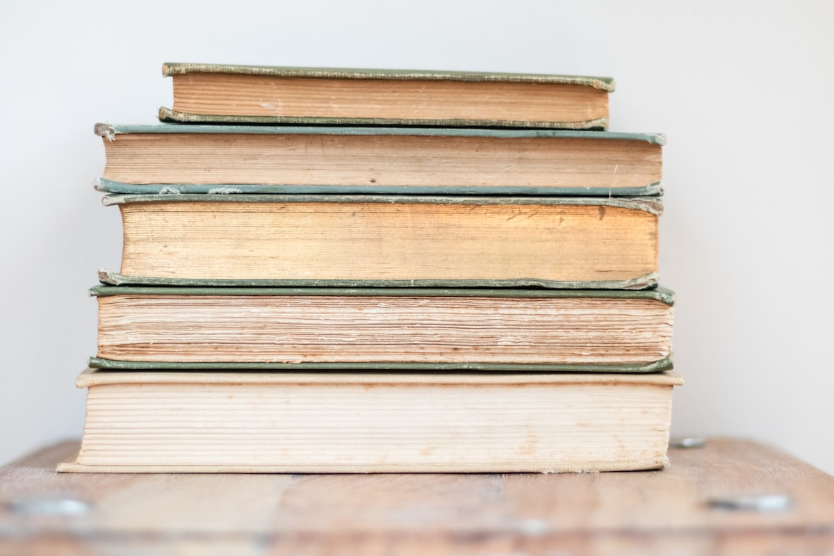 A stack of previous-year question paper books on a study desk