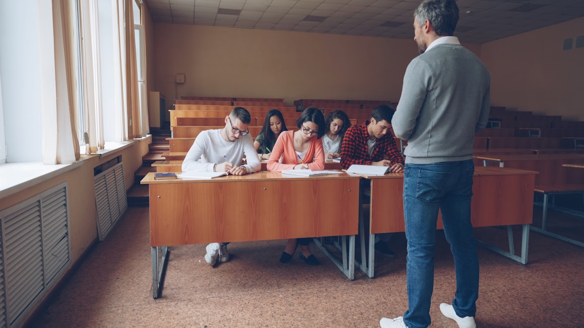 Students writing an exam in a lecture hall — SSC CGL 2026 preparation