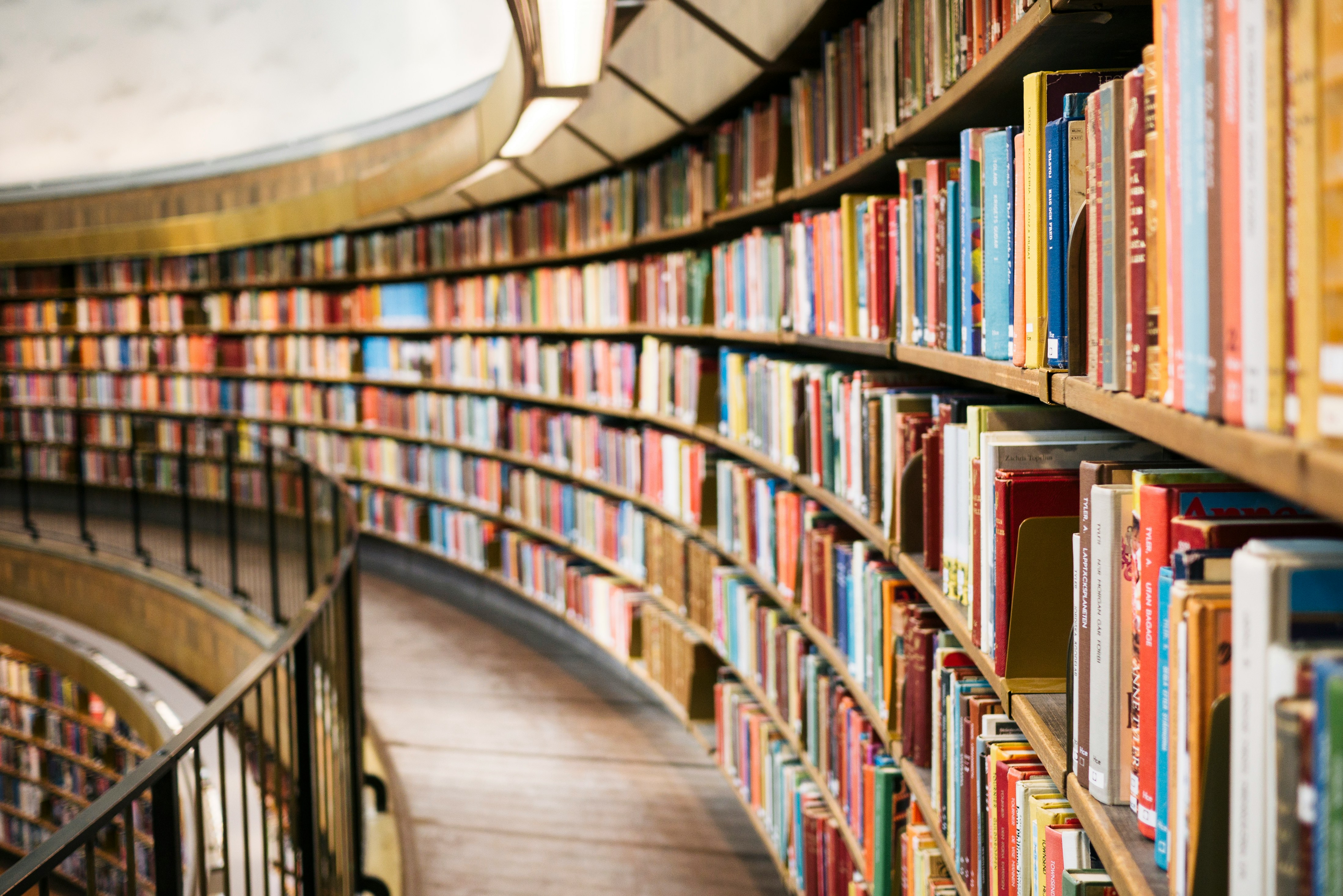 Library bookshelves curving โ representing the breadth of UPSC Civil Services preparation